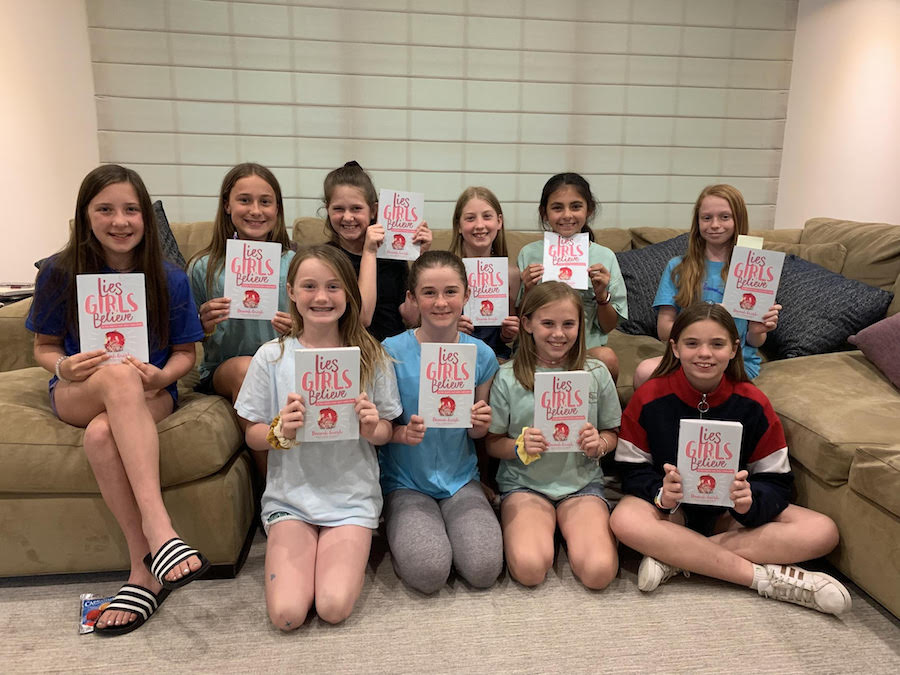 Group of girls holding up their copies of Lies Girls Believe 