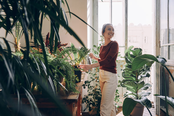 Woman tending to a plant