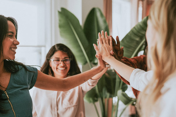 Women high fiving in a group
